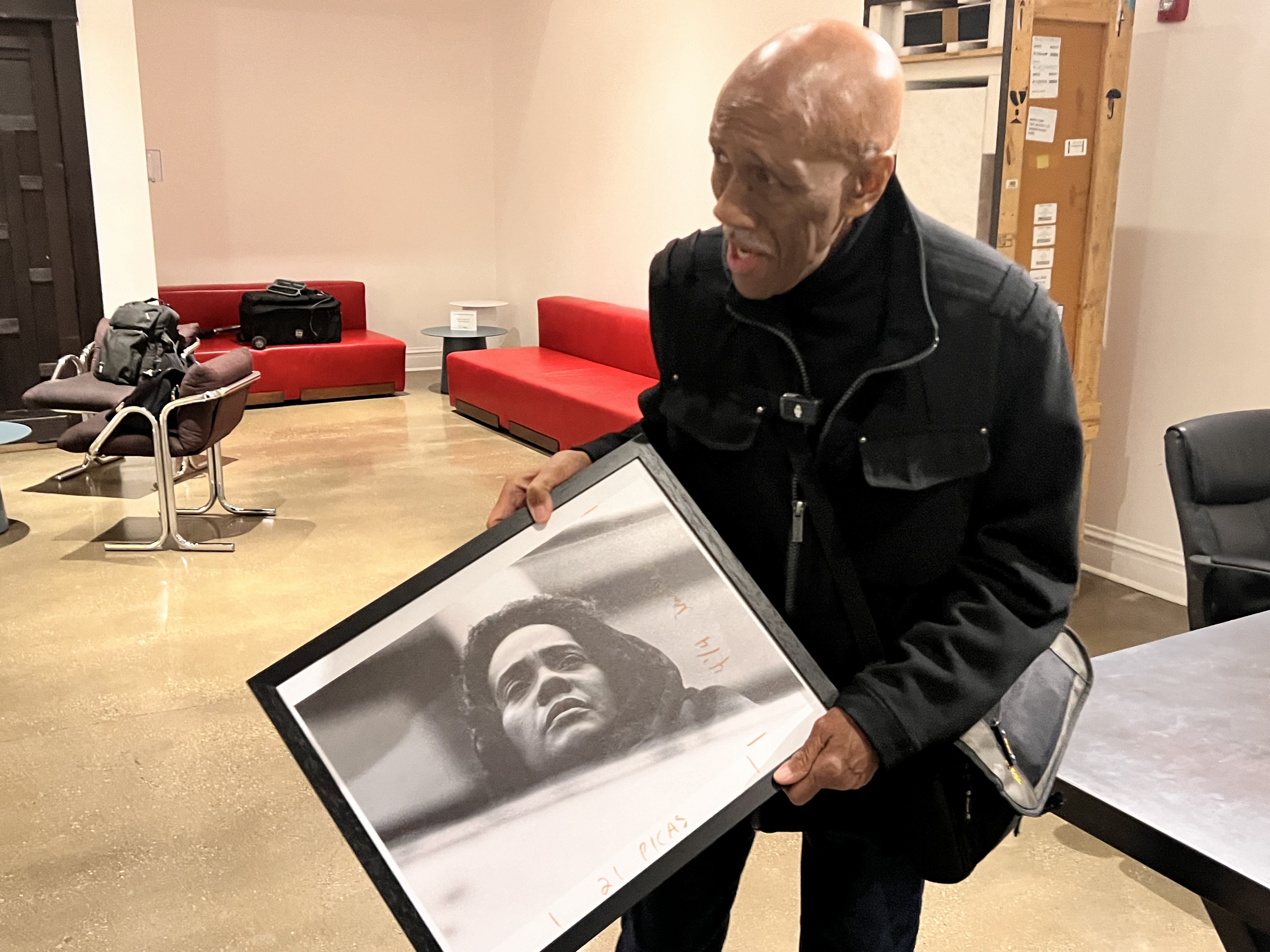 Howard D. Simmons holding a framed photograph