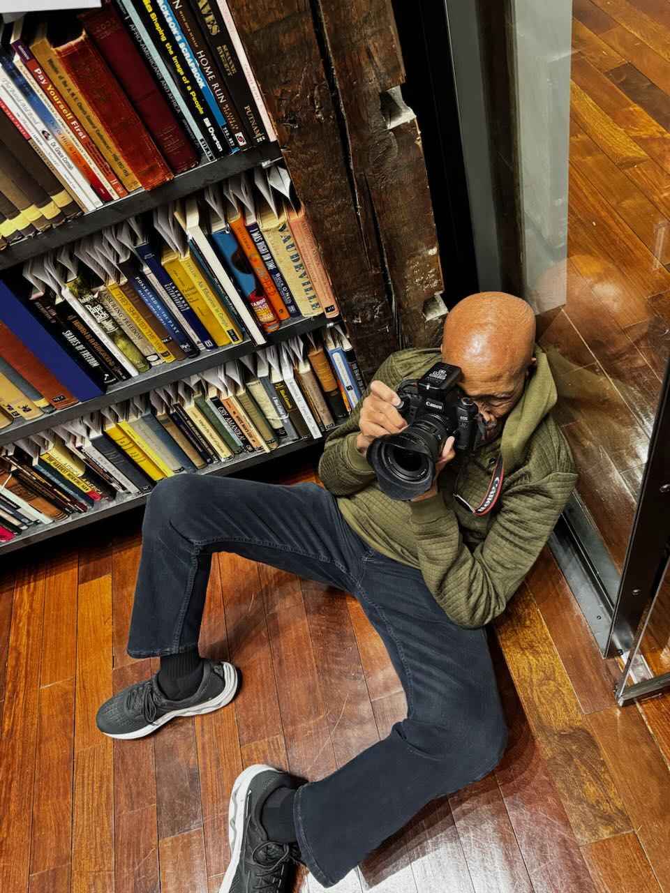 Howard D. Simmons photographing in a library